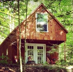 Bentley's cabin, a red-sided cabin tucked among trees